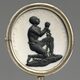 A medallion with the image of a kneeling, chained black man with clasped hands surrounded by the words "Am I not a man and a brother?"