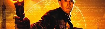 Nicolas Cage holds a torch and a book while standing in front of floating text and several large national monuments.