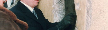 Vaclav Havel looks trough a hole of the Wall at the East side near Brandenburg Gate, Tuesday, January 02, 1990