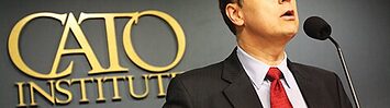 David Boaz stands behind a lectern, with the Cato Institute logo on the wall behind him.