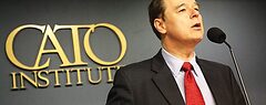David Boaz stands behind a lectern, with the Cato Institute logo on the wall behind him.